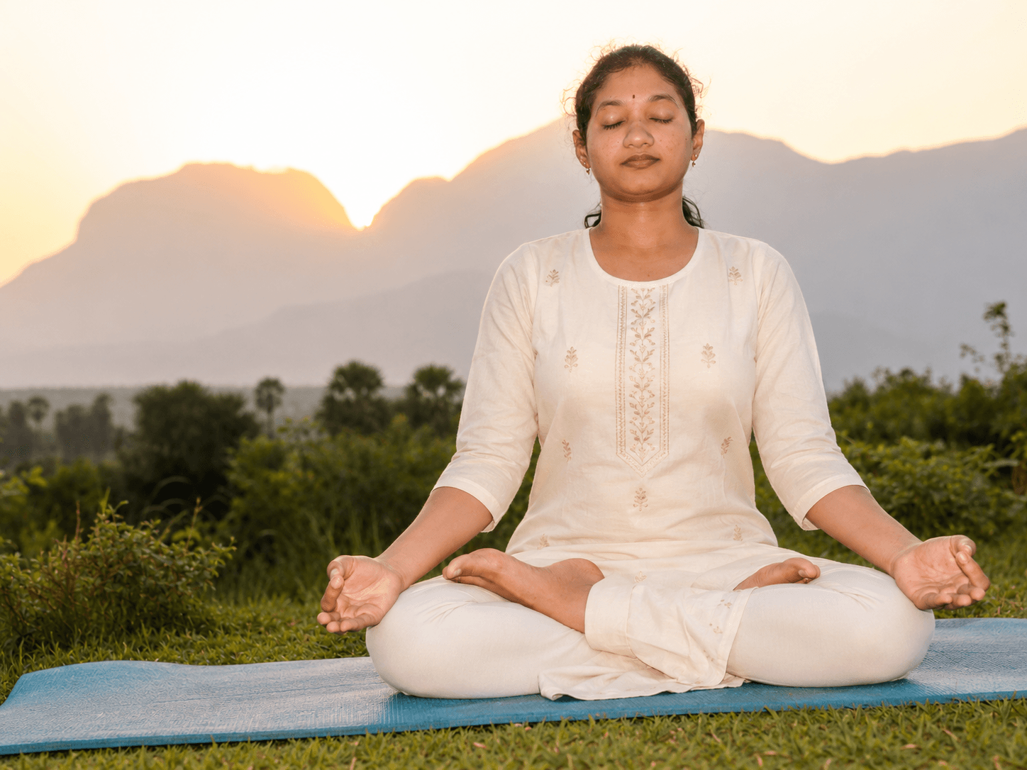 Vani Guntumadugu meditating outdoors at sunrise