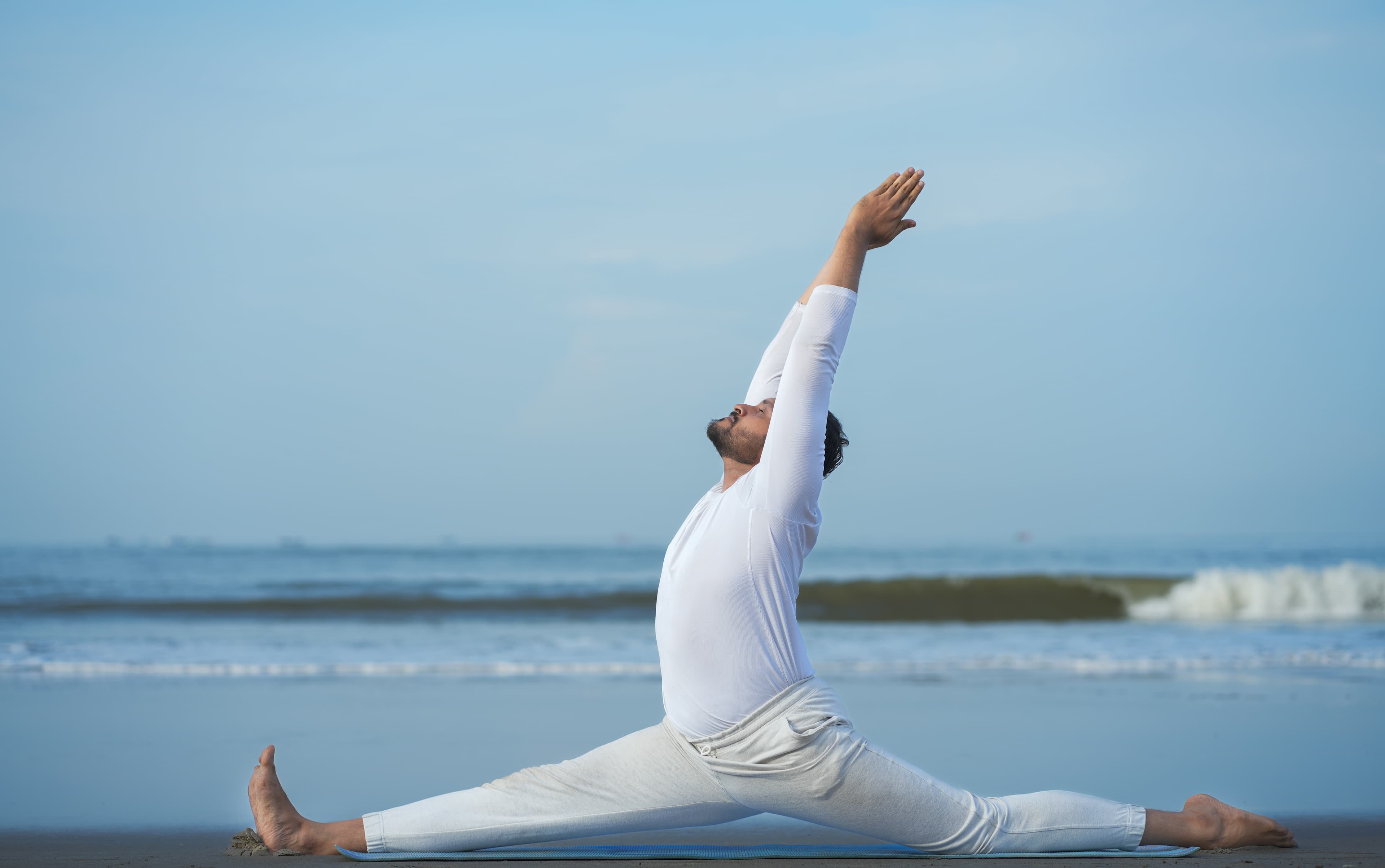 A calm yoga lunge practice beside the sea